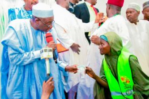 Governor Namadi with one of the beneficiaries during the launching.jpg
