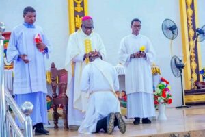 Bishop Ajang(middle) laying hands on a former deacon.jpg