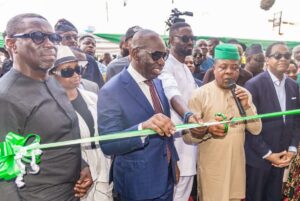 Ihedioha cutting the project tape, while Obasek, second left and Duke, right, look on.jpg