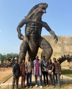 Senator Ojudu's, centre, with the artists under an imposing Godzilla created from scraps