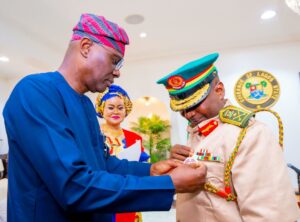 Governor of Lagos State, Mr. Babajide Sanwo-Olu decorating Chairman, Nigerian Legion, Lagos command, DCG Hakeem Wolimoh (right), while the Secretary to the State Government, Barr. ‘Bimbola Salu-Hundeyin (middle) looks on during the launch of the Year 2025 Armed Forces Remembrance Day Emblem and Appeal Fund, at the Lagos House, Marina, on Monday, 16 December 2024.