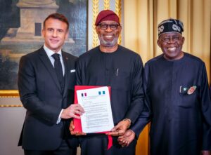 R-L: President Bola Tinubu; Solid Minerals Development Minister, Dr. Dele Alake and President of France, Emmanuel Macron displaying the Memorandum of Understanding (MOU) on Solid Minerals Development between both countries during President Tinubu's official visit to France. 1st December, 2024.