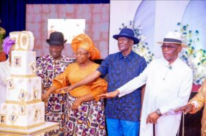 Retired Navy Captain Caleb Omoniyi Olubolade and well wishers during the birthday cutting of cake.jpg