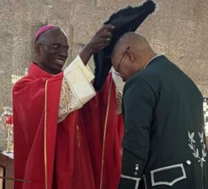 Prince Julius Adelusi-Adeluyi receiving the Knighthood from Bishop of the Catholic Diocese of Ekiti, Fr Felix Femi Ajakaiye who represented the Pope.jpg