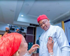 Coordinator of Military Widows Association in Imo State, Mrs. Joy Moses, decorates Governor Hope Uzodimma with the Armed Forces Remembrance Day emblem during the launch and fund raising ceremony at the Sam Mbakwe Executive Chambers, Government House Owerri... Wednesday