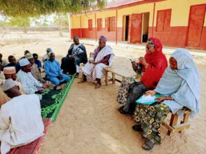 Officials of Kano state Ministry of Education and villagers discussing the way forward on the syndrome of out-of-school children in the state