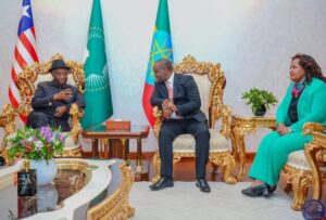 President Boakai, left, Ethiopia Minister of Transport and government official at the VIP lounge at Bole International Airport