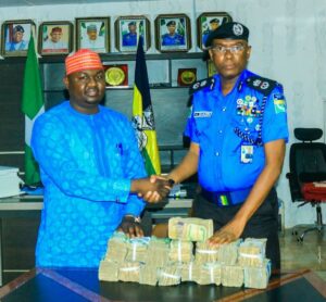 (CP Bakori handing over the recovered ransom to the Chairman, Gabasawa Local Government Area