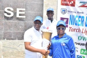 Deputy Governor of Imo State, Lady Chinyere Ekomaru who represented Governor Hope Uzodimma (right), receives the NDDC Sports Festival Torch of Unity Light with the Imo State Commissioner for Sports and Youth Development, Hon. Obinna Onyeocha when the officials of the up coming Festival called at Government House, Owerri... Thursday.