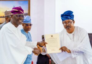 Governor of Lagos State, Mr. Babajide Sanwo-Olu presenting the oath office to Otunba Oladipupo Oluwaloni as the Chairman of Ayobo-Ipaja LCDA, during the swearing-in ceremony at Lagos House, Ikeja, on Thursday, 03 April, 2025.