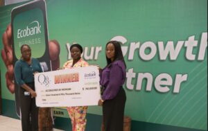 Tomilola Fetuga (left), Head of Brand Management and Experiential Marketing, and Omoboye Odu (right), Head of SME Banking, both of Ecobank Nigeria, presenting a cash prize to a representative of Accessories by Morgan for recording the highest volume of transactions during the ‘Oja Oge by Ecobank’ fair held in Lagos.