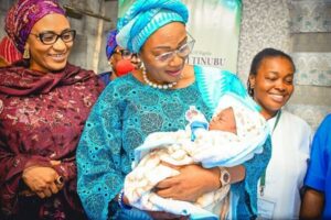 First Lady Oluremi Tinubu holding a baby in one of her state visits