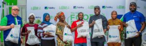 Henry Asiegbu, Divisional Head, Operations, Fidelity Bank Plc (Left); Adebayo Adeyinka, Executive Technical Assistant to the Managing Director/Chief Executive Officer, Fidelity Bank Plc (5th from Left); Meksley Nwagboh, Divisional Head, Brand and Communications, Fidelity Bank Plc (Right); flanked by some of the beneficiaries at the Fidelity Food Bank outreach in Eti Osa Local Government Area, Lagos recently.