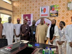Waiya flanked by officials from Kiru Reformative Centre