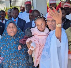 Governor Yusuf carrying one of the twins