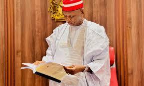 Governor Yusuf reading a document