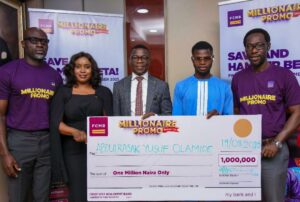 Divisional Head, Personal Banking, First City Monument Bank (FCMB), Mr. Adetunji Lamidi, presenting a cheque to Mr. AbdulRasak Yusuf, one of the winners of ₦1 million in the sixth draw of the FCMB Millionaire Promo Season 10 at a ceremony in Lagos recently