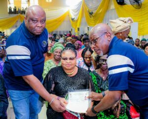 Executive Director, Finance & Investment, Lagos State Pension Commission (LASPEC), Mr. Olumuyiwa Oshin (left); LASPEC Director General, Mr. Babalola Obilana (right) with a beneficiary during the 110th batch retirement bond presentation ceremony, at the Adeyemi Bero Auditorium, the Secretariat, Alausa, Ikeja, on Monday, September 8, 2025.