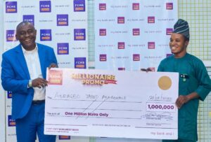Zonal Head, South-west 2, First City Monument Bank (FCMB), Mr. Matthew Ofolue, presenting a cheque to Mr. Adeagbo Taiwo, one of the winners of ₦1 million in the sixth draw of the FCMB Millionaire Promo Season 10 at a ceremony in Ile-Ife, Osun State recently.