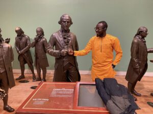 Here, Olawyin did a chop-knockle with George Washington