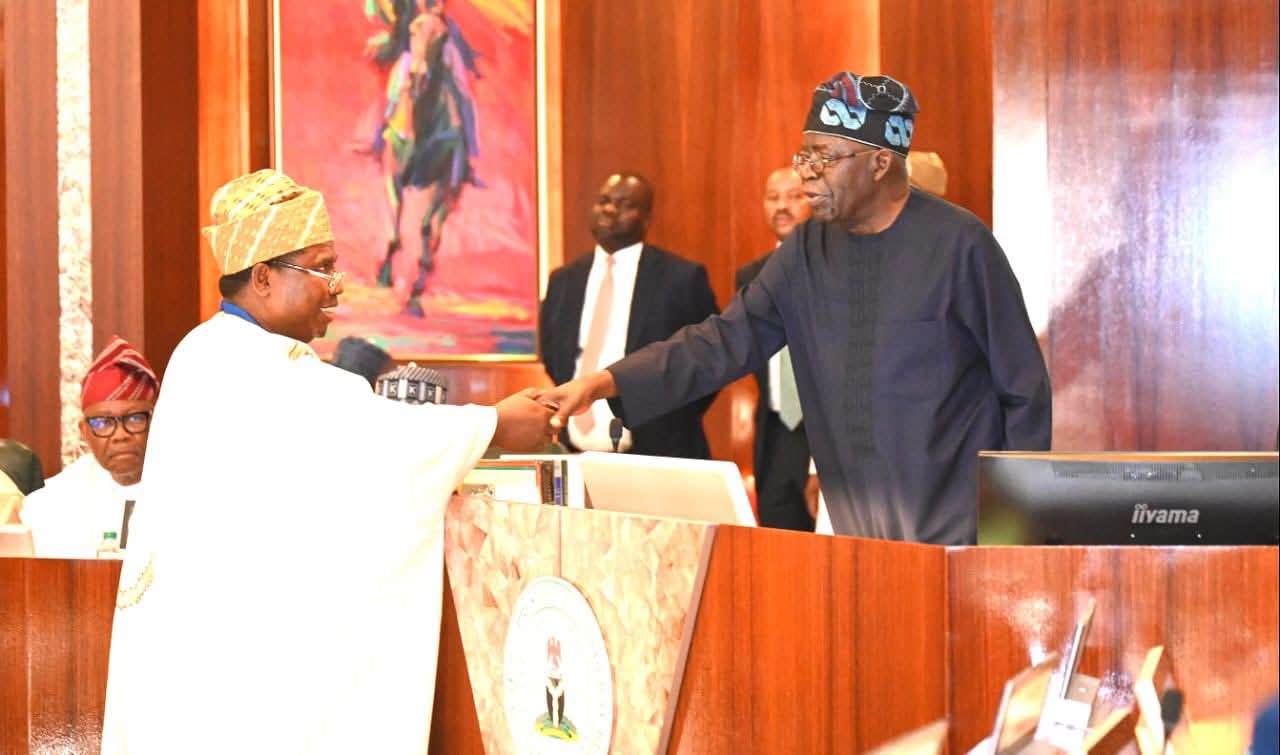President Bola Tinubu congratulating the new INEC Chairman, Professor Joash Amupitan