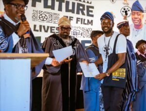 Kunle Afolayan presenting a certificate to a graduating students