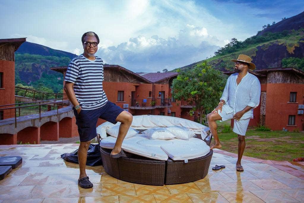 Kunle Afolayan, right, and a guest at the gate of his KAP Film village