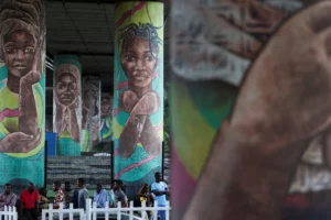 People sit under the Falomo Bridge, where murals depicting the abduction of over two hundred Chibok schoolgirls by Boko Haram are displayed, on the day Nigerians mark the eleventh anniversary of the abduction, in Ikoyi, Lagos, Nigeria, on April 14, 2025. Sodiq Adelakun/REUTERS