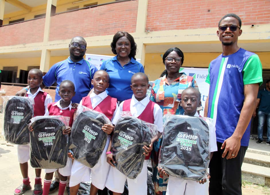 L-R: Ahmed Adebisi, Member, Eminence Inductees Class of 2025, Fidelity Bank Plc; Victoria Abuka, Team Lead, Corporate Social Responsibility (CSR), Fidelity Bank Plc; Folasade Kasunmu, Vice Principal, Eko Boys’ Junior High School, Mushin; and Chinwendu Chukwujekwu, Member, Eminence Inductees Class of 2025, Fidelity Bank Plc; with students of Eko Boys’ Junior High School, at the donation of school bags and notebooks to the students in Mushin, Lagos recently.