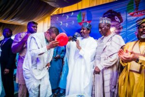 Senator Barau Ibrahim Jibrin receiving one of the NNPP decampees