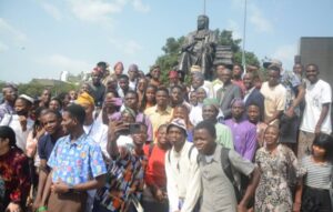 Students of the university in a photo session with the bronze statue