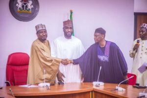 L-R: Barau Jibrin, deputy senate president, receiving Abba Atiku Abubakar into APC
