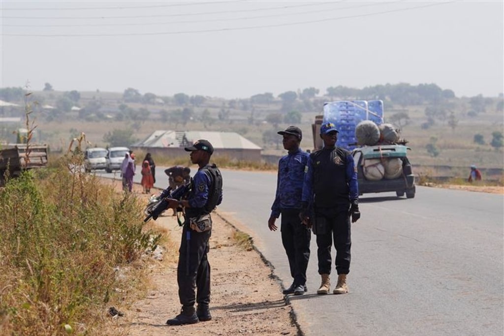 Members of the Civilian Joint Task Force stand guard during a drill near a bush in Minna, Niger state, Nigeria, on November 29, 2025. Vigilante groups have stepped in to fill security gaps as rural communities face rising attacks and abductions by armed gangs. Marvellous Durowaiye/REUTERS