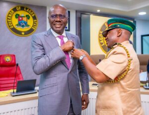 Governor of Lagos State, Mr. Babajide Sanwo-Olu being decorated by the Chairman, Nigerian Legion, Lagos command, DCG Hakeem Wolimoh during the launch of the Year 2026 Armed Forces Remembrance Day Emblem and Appeal Fund, at the EXCO Chamber, Lagos House, Ikeja, on Monday, January 05, 2026.