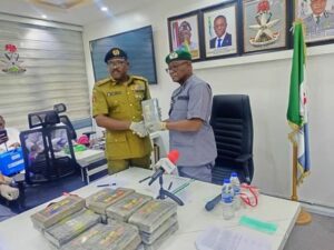 Timi Bomodi handing over the packages