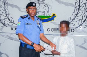 CP Bakori handing over a cheque to one of the beneficiaries