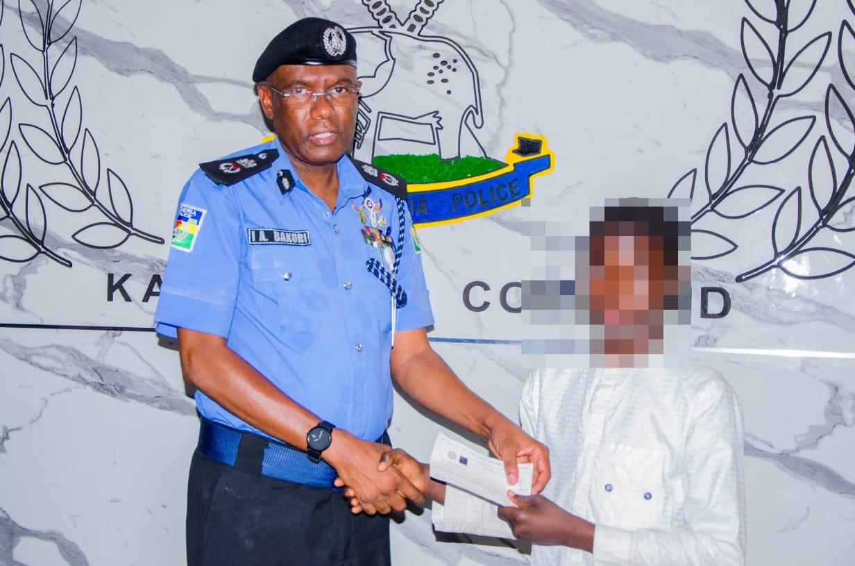 CP Bakori handing over a cheque to one of the beneficiaries