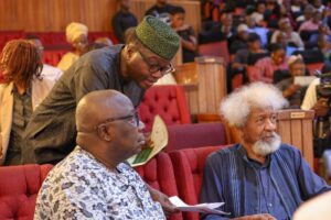Dapo Olorunyomi, left, Professor Wole Soyinka, right, and Kunle Ajibade standing