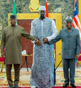 Guinea’s President, Mamadi Doumbouya, centre, with President Maada Bio, left, and President Joseph Boakai, right, after concluding a peace deal in Conakry yesterday