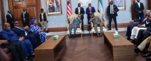 President Boakai, left, discussing with Maada Bio on arrival in Conakry on Monday, 16 March, 2026