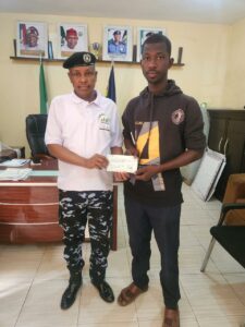 One of the beneficiaries receiving a cheque from AIG Ahmed