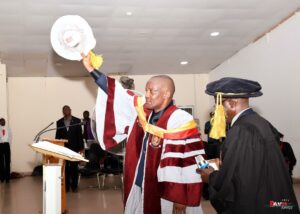 Prof Ehiyamen Mediayanose Osezua acknowledges cheers with the Registrar, Mr Abiodun Peter Okunniga behind him